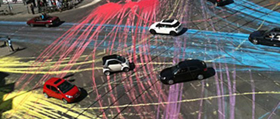 A photo of a road intersection with cars, with paths taken highlightd in different colors. Copyright http://nationaltrafficsurveys.com.au